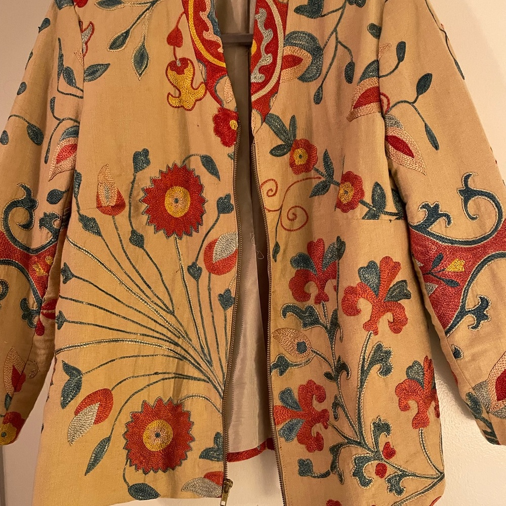 This jacket is lined with zipper in front . Great to wear dressy or with jeans.